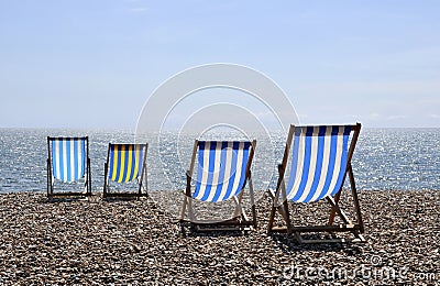 Deck chairs on Brighton beach Stock Photo