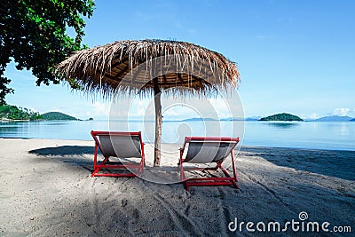 Deck chairs and umbrella on tropical beach scenery. Koh Mark Thailand Stock Photo