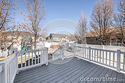 Deck of a house with a view of a playground in the backyard Stock Photo