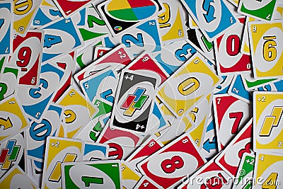 Deck of Uno game cards scattered all over on a table. American card game. Editorial Stock Photo