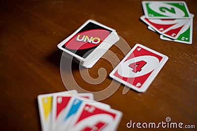 Deck of Uno game cards scattered all over on a table. American card game. Editorial Stock Photo