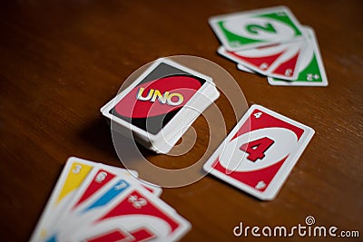 Deck of Uno game cards scattered all over on a table. American card game. Editorial Stock Photo