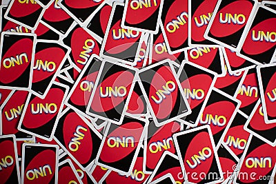 Deck of Uno game cards scattered all over on a table. American card game. Editorial Stock Photo