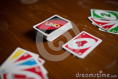 Deck of Uno game cards scattered all over on a table. American card game. Editorial Stock Photo