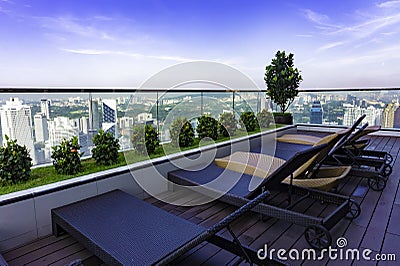 Deckchairs on roof of scyscraper in Kuala Lumpur. Stock Photo