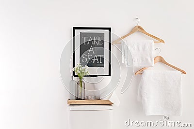 Decor elements, necessities and toilet bowl near white wall. Bathroom interior Stock Photo