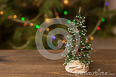 Decorated Christmas small tree on wooden table with glowing background Stock Photo