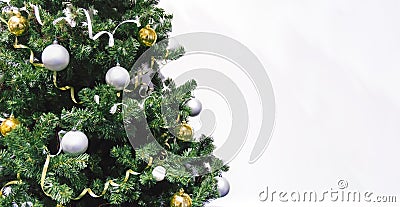 decorated Christmas tree with gifts close up on white background. Christmas tree decorated with yellow and white balls and tinsel. Stock Photo