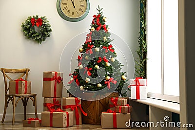 Decorated Christmas tree with gifts. Festive Stock Photo