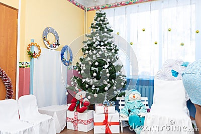 Decorated Christmas tree, snowmen and gifts on New Year& x27;s holiday Stock Photo