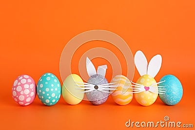 Decorated Easter eggs and cute bunny`s ears on background Stock Photo