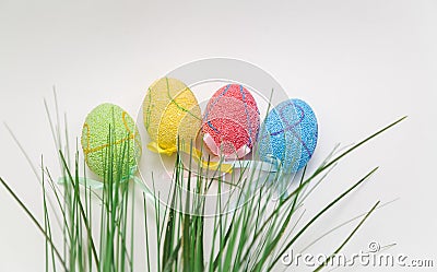 decorated Easter eggs and green grass on grey background Stock Photo