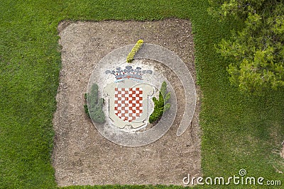 Decorated garden with shield of de city, Tarragona. Editorial Stock Photo