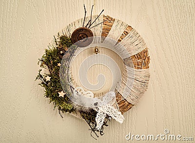 Decorated handmade Christmas wreath hanging on the wooden door Stock Photo