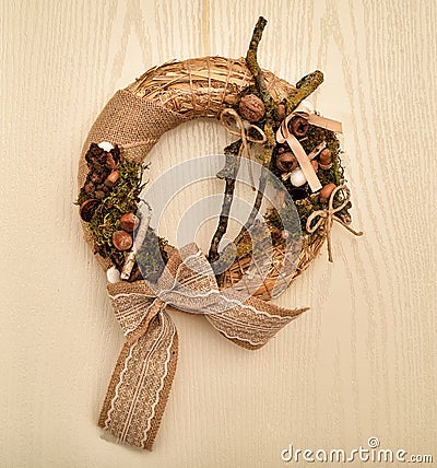 Decorated handmade Christmas wreath hanging on the wooden door Stock Photo