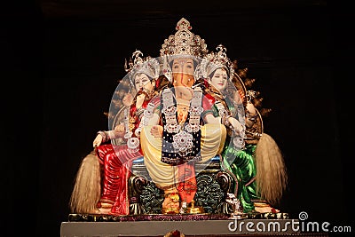 Decorated idol of Lord Ganesha with black background. Stock Photo