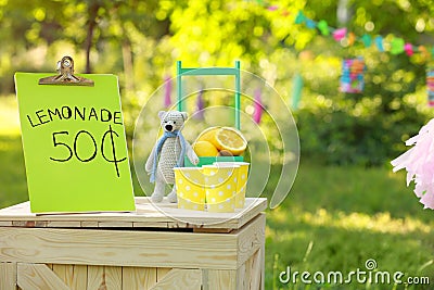Decorated lemonade stand in park. Refreshing natural drink Stock Photo