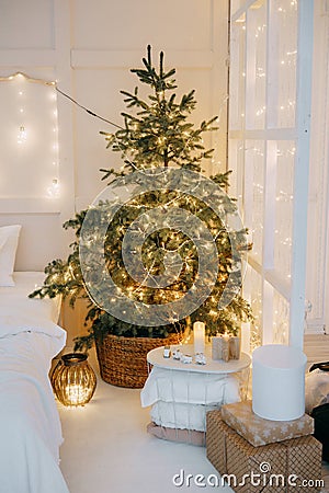 Decorated mirror and live Christmas tree with lights. New year's interior, festive atmosphere, decor, garlands Stock Photo