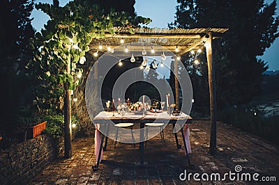 Decorated outdoor wedding table with flowers in rustic style Stock Photo