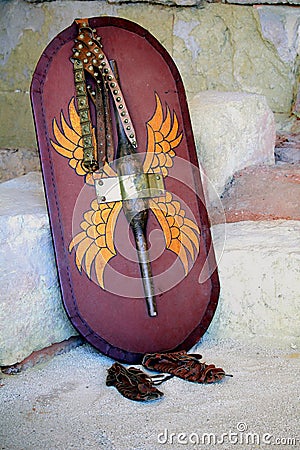 Decorated Roman scutum shield, studded belt and leather sandals Stock Photo