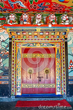 Decorated, with a skillfully made and ornate doorknobs entrance to a temple of the Rumtek Buddhist monastery Stock Photo