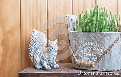 Decorated a squirrel statue and green flower pot in vintage style Stock Photo