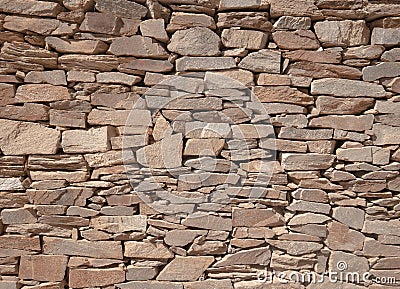 Decorated stone wall in the garden of a villa in Sardinia Stock Photo