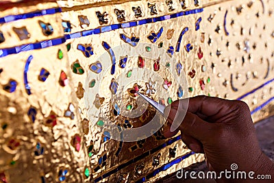 Decorating the base of the image of Buddha with stained glass Stock Photo