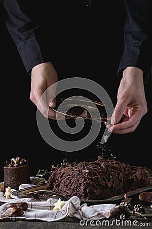 Decorating of christmas chocolate yule log Stock Photo