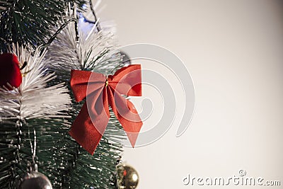 Decorating a Christmas tree with a red loop, creating a beautiful and harmonious setting Stock Photo