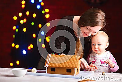 Decorating gingerbread house Stock Photo