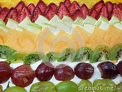 decoration of a cake with slices of various fruits, background and texture Stock Photo