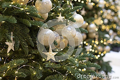 Decoration with a Christmas tree decorated with a golden ball and a star. Sparkling shining festive new year background Stock Photo