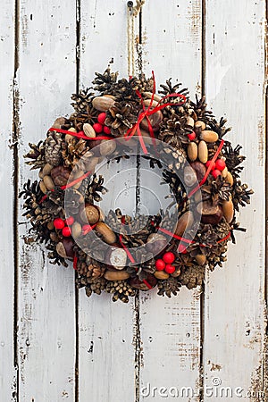 Decoration christmas wreath on white rusty wooden board backround, natural wreath, vertical Stock Photo