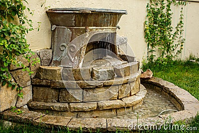 Decoration of the exterior in the form of a waterfall of stones in the old style Stock Photo