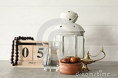 Decoration and food of Ramadan Kareem holiday with calendar on grey table Stock Photo