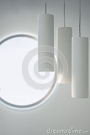 Decoration with three identical white lamps hanging Stock Photo