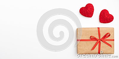 Decoration valentine`s day on table desk top view with present box. Flat lay composition of red heart and craft paper gift box Stock Photo