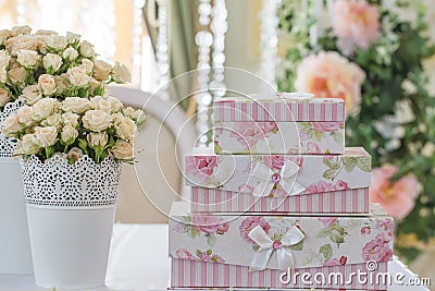 Decoration of wedding table. Lupin in vase with gift boxes that Stock Photo