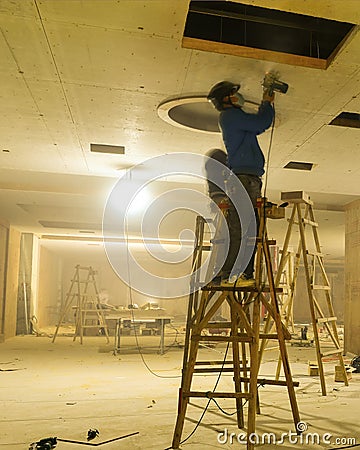 Decoration workers spruce up the ceiling Stock Photo
