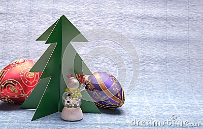 Snowman and green tree on blue background Stock Photo