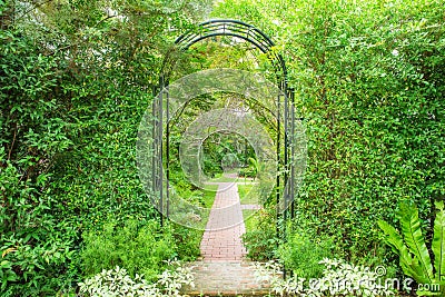 Decorative arched iron gateway to a garden Stock Photo