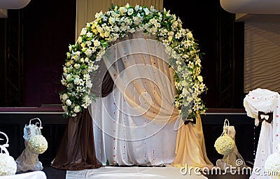 Decorative arched white floral bridal bower Stock Photo