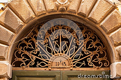 Decorative arched window above a door Stock Photo