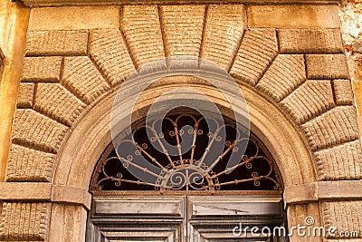 Decorative arched window above a door Stock Photo