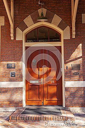 Decorative arched wooden door of an 18th century historic building in Rockville. Editorial Stock Photo