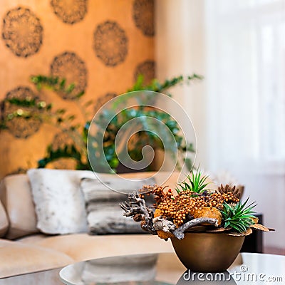 Decorative bouquet of flowers on the table in orange living room Stock Photo
