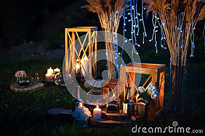 Night wedding ceremony with a lot of lights, candles, lanterns. Beautiful romantic shining decorations in twilight Stock Photo