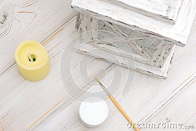 Decorative carton lantern with a piece of cardboard, glue gun and hot glue on a white wooden table Stock Photo