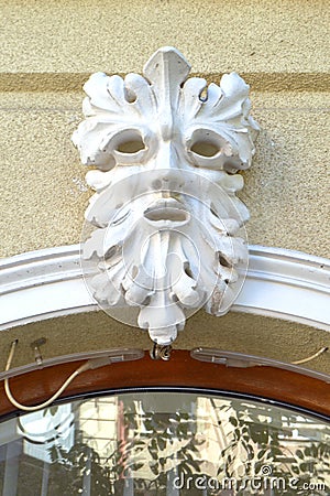 Decorative carved face on building facade Stock Photo